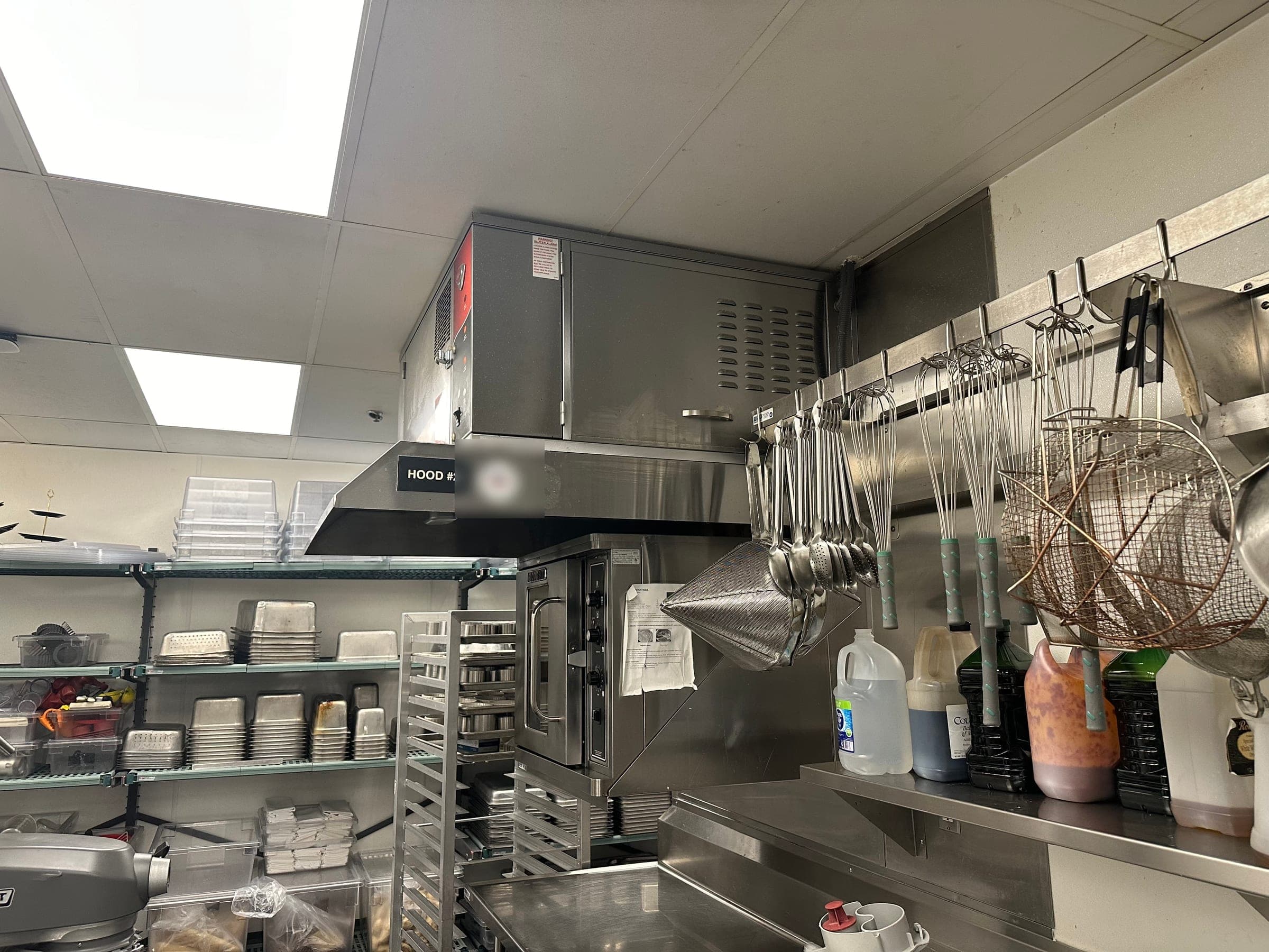 Wells ventless hood marked Hood #2 above a countertop oven in a commercial kitchen