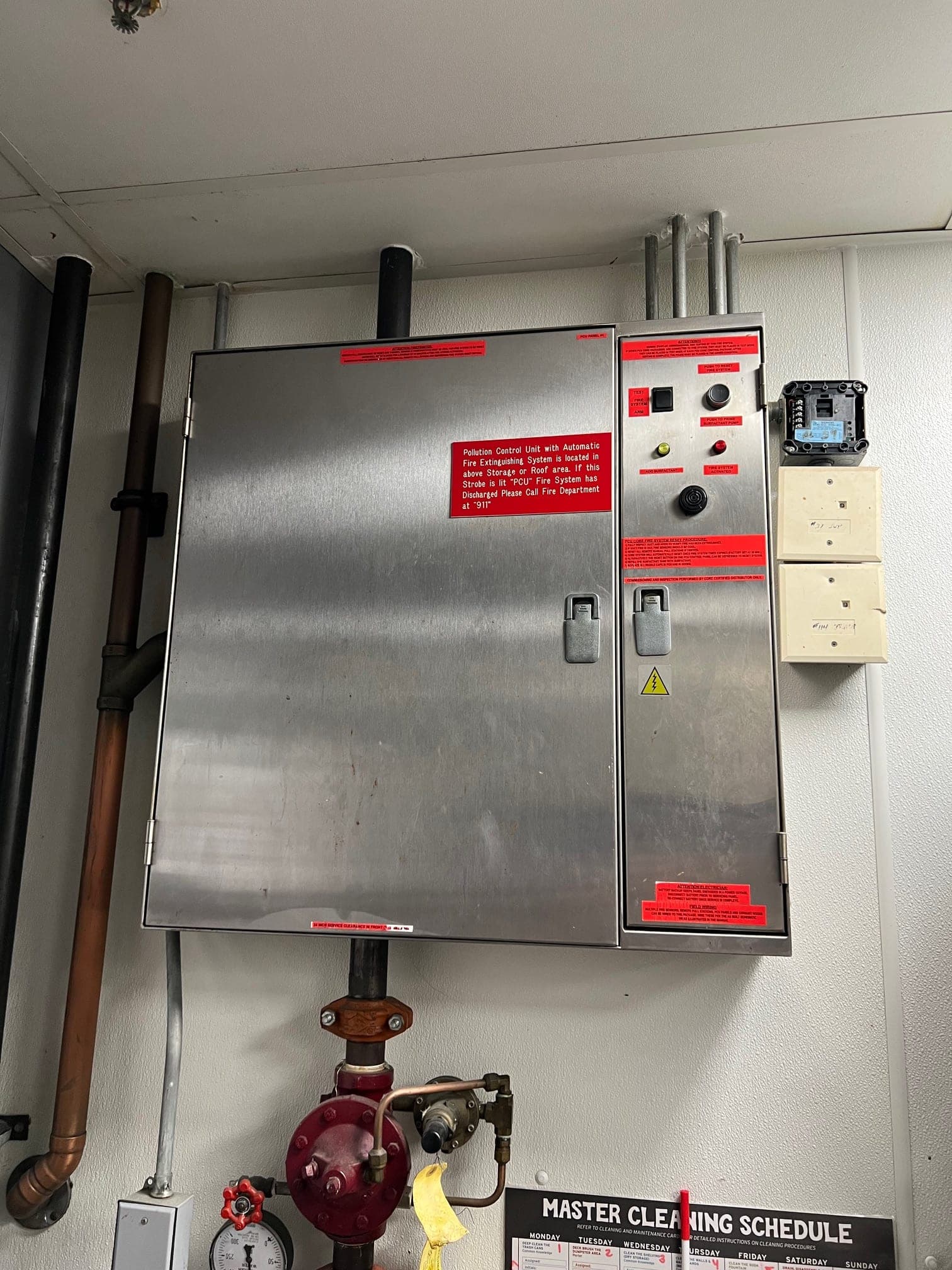 Stainless CaptiveAire control cabinet for the pollution control unit, with a fire strobe and warning labels