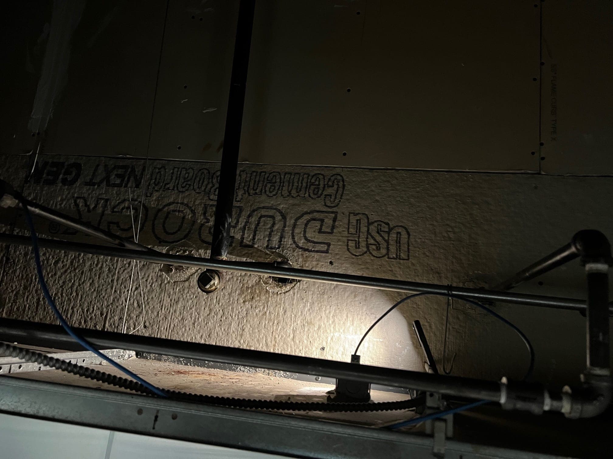 Suppression branch line and nozzle drops above the cooking line, seen from below the ceiling